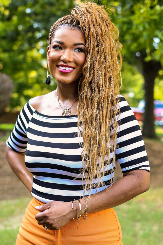 woman wearing black and whit stripe shirt with bohemian box braids